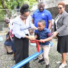 Claudine Allen (left), General Manager of the JN Foundation, helps a student of Chapel Hill Basic School enjoy the seesaw, as Norman Hinds, President of the JN Circle Morant Bay chapter, and Nina Peters, Business Relationship and Sales Manager at JN Bank, look on with smiles.